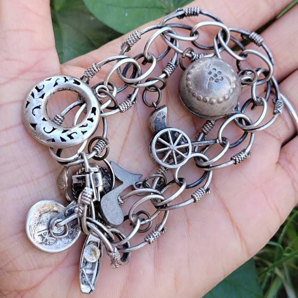 Amazing vintage 1950s LOADED sterling silver ornate charm bracelet
